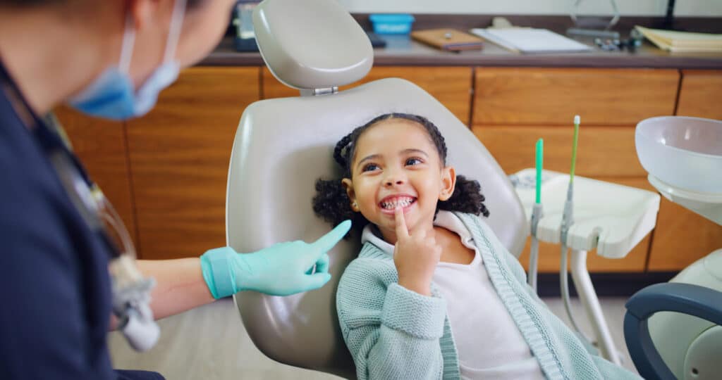 Pediatric dental patient smiling while visitng the dentist