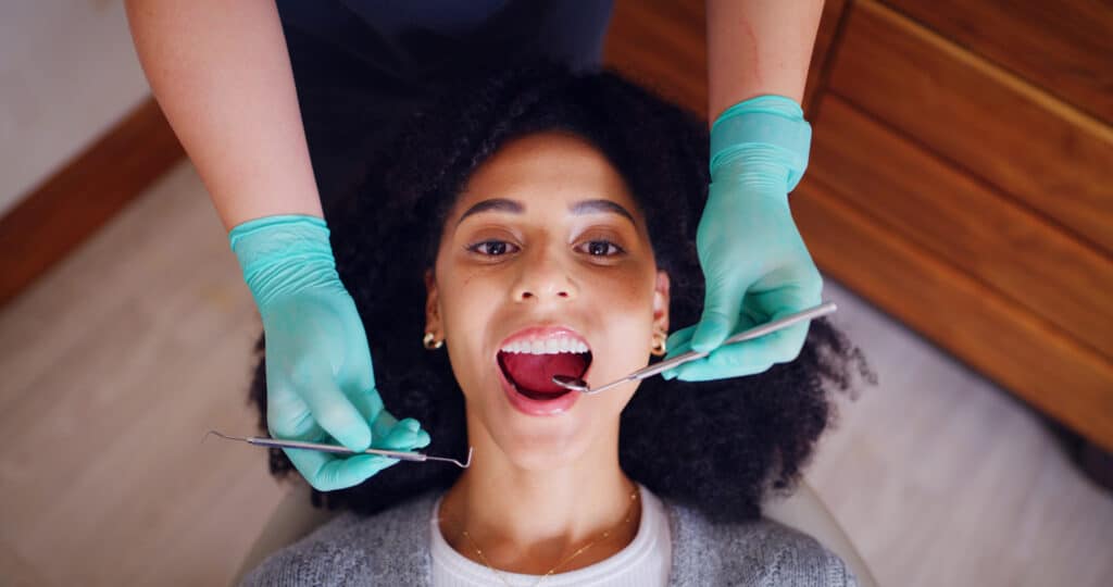 Dentist examining a dental patient for cavities
